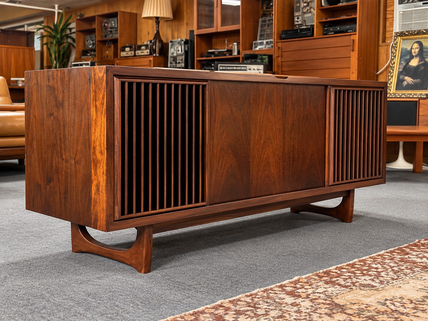 Walnut mid-century stereo console with slatted speaker grilles, on display at Atomic Furnishing & Design