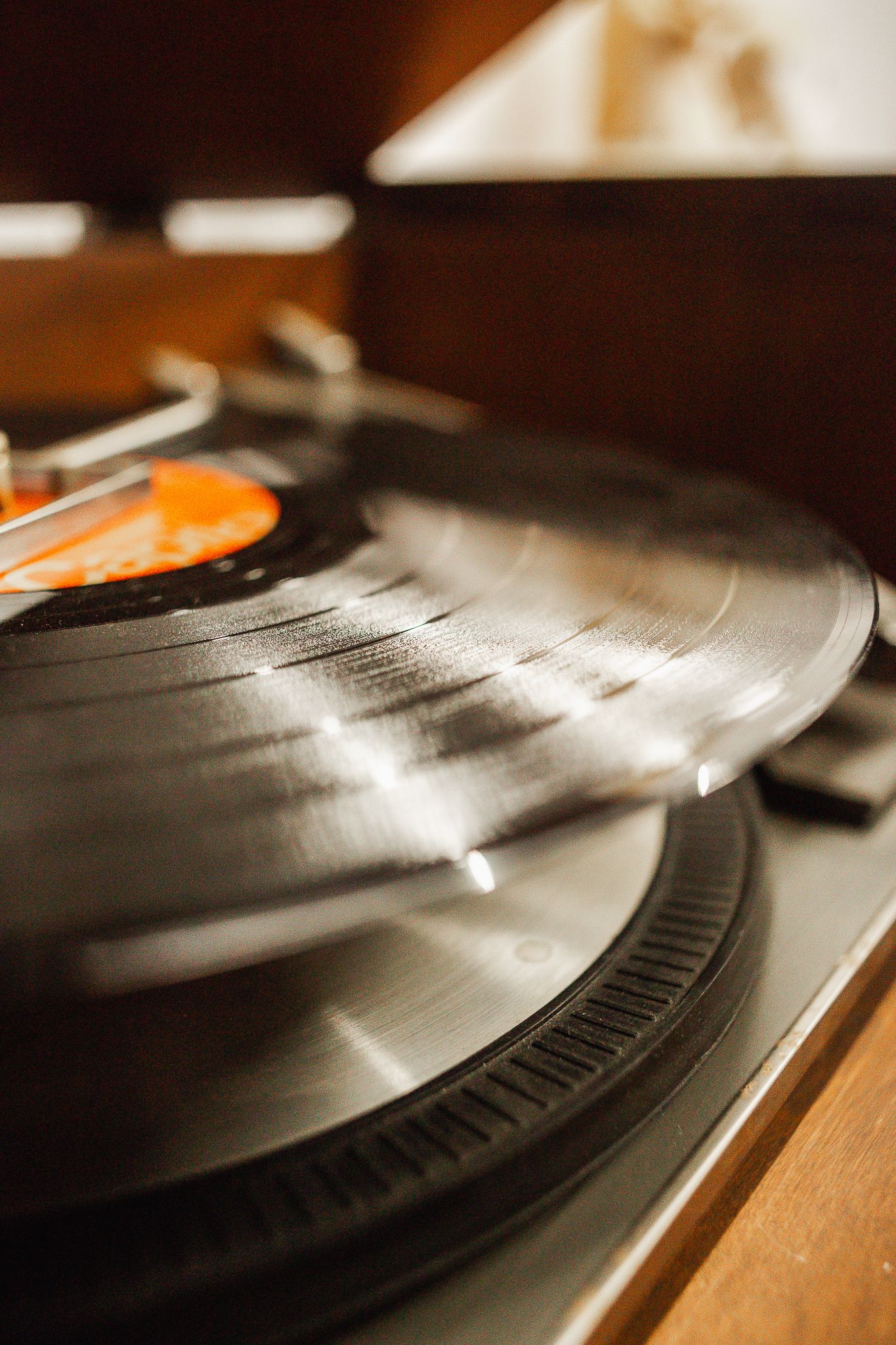 Close-up of a vinyl record spinning on a console turntable