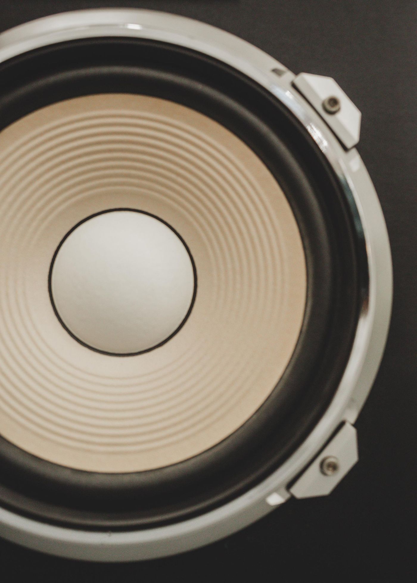 Close-up of a vintage speaker with a chrome ring