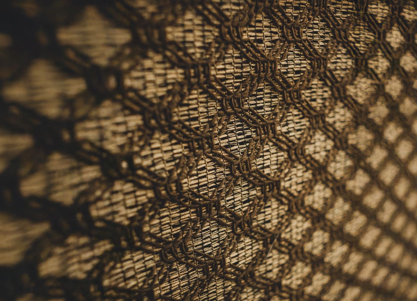 Close-up of the woven grille cloth on a vintage console